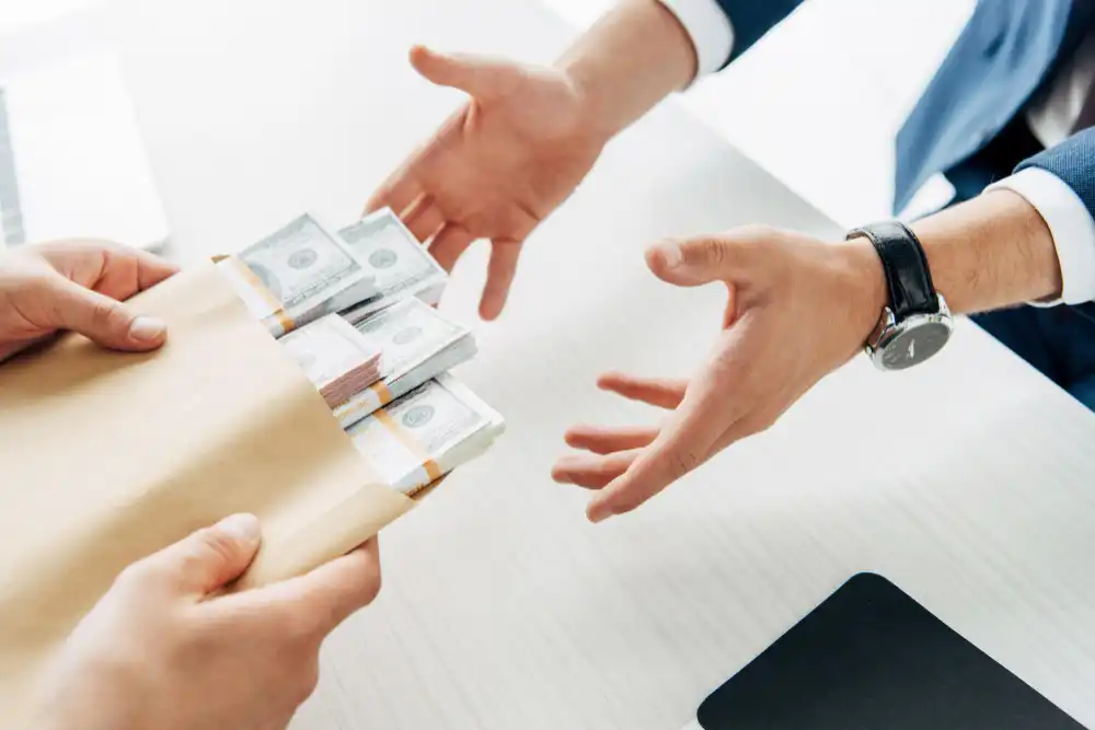 202402061486.webp cropped-view-man-taking-envelope-with-cash-near-business-partner.webp