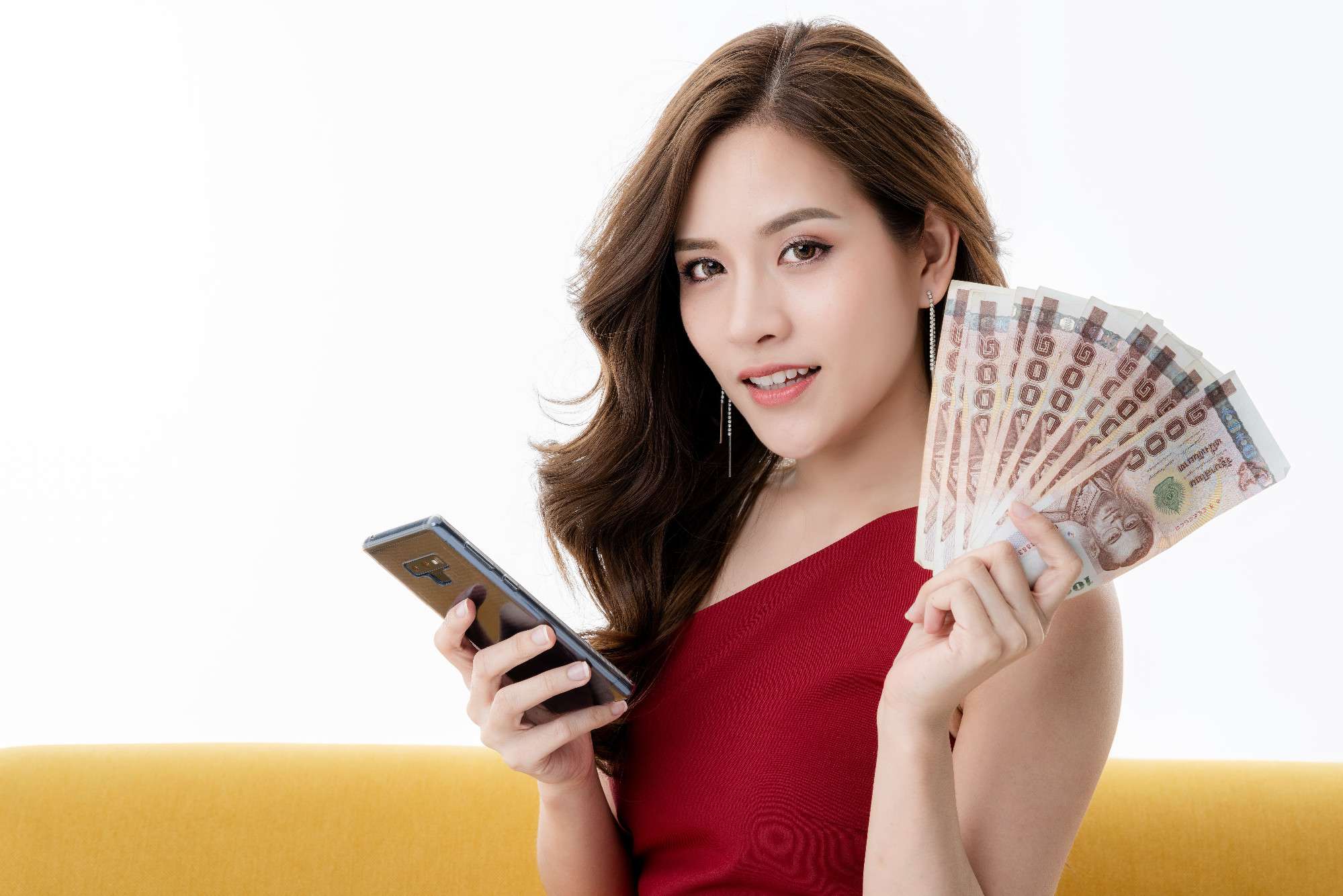 beautiful-attractive-elegance-asian-woman-red-dress-sit-relax-model-pose-hand-hold-money-smartphone-yellow-sofa-studio-photo-shoot (1).jpg